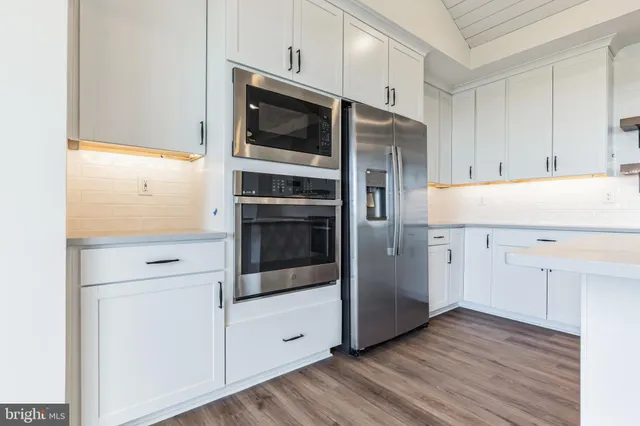 a kitchen with stainless steel appliances and wooden cabinets