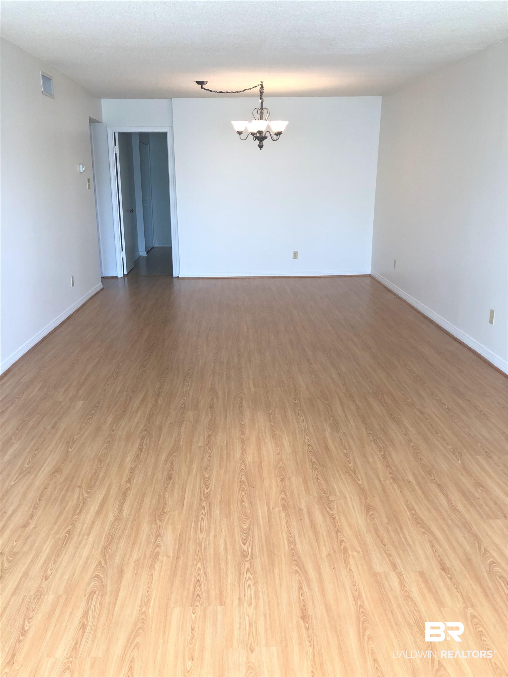 4009 Old Shell Road, Unit C12 Mobile, AL 36608 - Photo 3 of 11 Unfurnished room with an inviting chandelier and light hardwood / wood-style floors