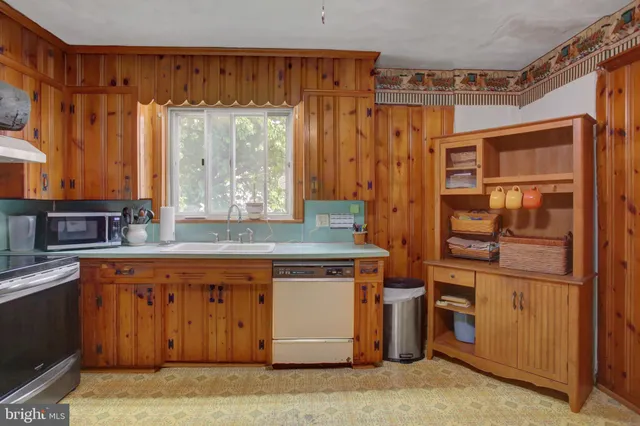 a hallway with a wooden floor and a cabinet
