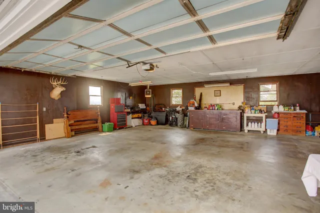 a bedroom with a bed window and a table
