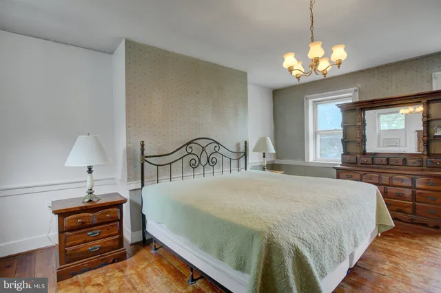 a room with furniture and a chandelier fan