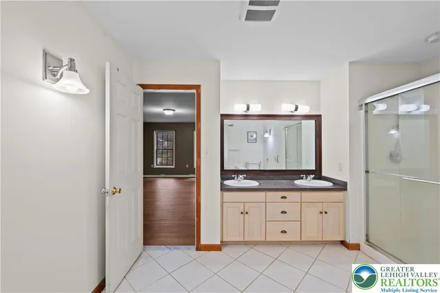 a bathroom with a granite countertop sink mirror and toilet
