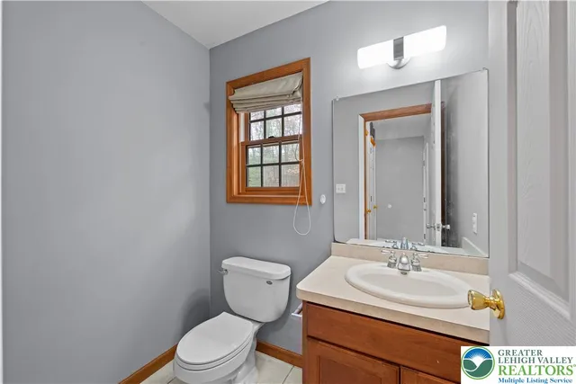 a bathroom with a sink toilet vanity and mirror