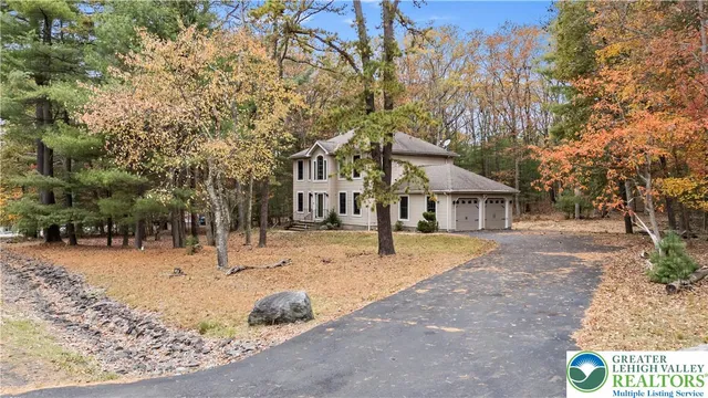 a view of a house with a yard covered in snow