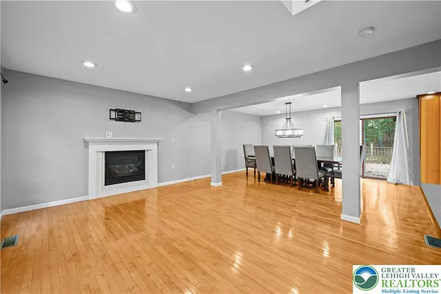 a view of an empty room with furniture and a fireplace
