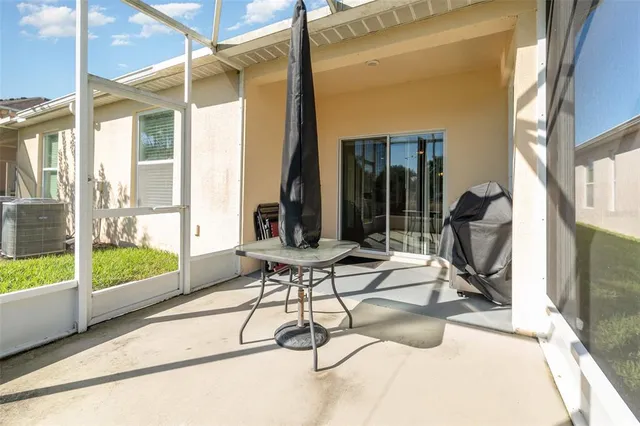 a view of a room with wooden floor and iron stairs