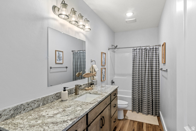 1343 North Trapper Loop Garden City, UT 84028 - Photo 37 of 56 Full bathroom featuring vanity, shower / bath combo, and dark wood-style floors