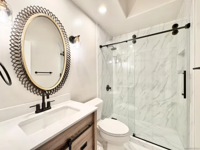 a bathroom with a sink a toilet and a mirror