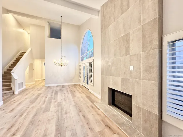 a view of a livingroom with wooden floor and staircase
