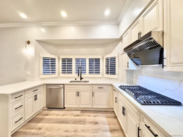 a kitchen with stainless steel appliances granite countertop a stove and a sink