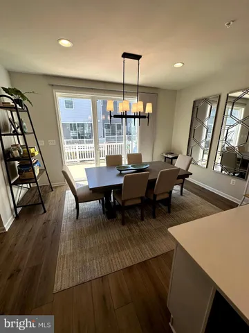 a dining room with furniture and wooden floor