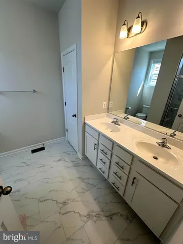 a bathroom with a double vanity sink mirror and