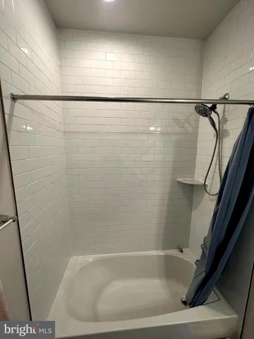 a bathroom with a shower and a bath tub