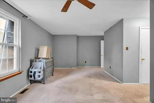 a bathroom with a granite countertop sink toilet and shower a mirror