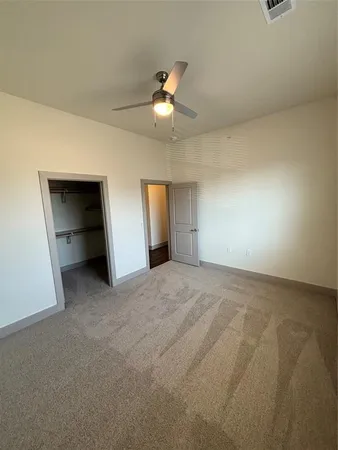 an empty room with closet and window