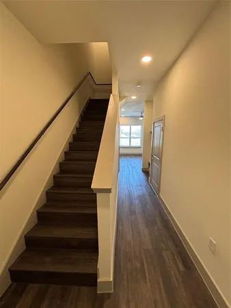 a view of entryway and hall with wooden floor