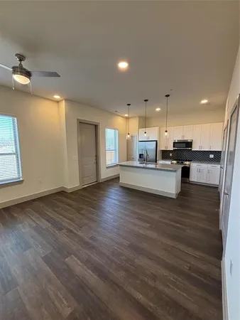 a view of kitchen with cabinets and wooden floor