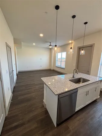 a kitchen with sink and mirror