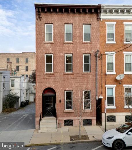 a front view of a building with parking space