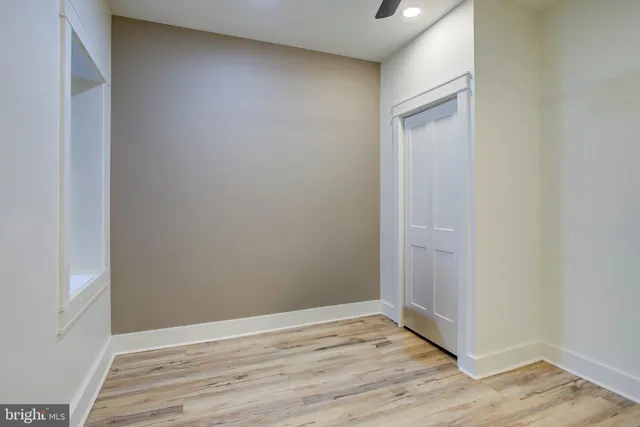 a view of an empty room with wooden floor