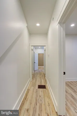 a view of hallway with wooden floor