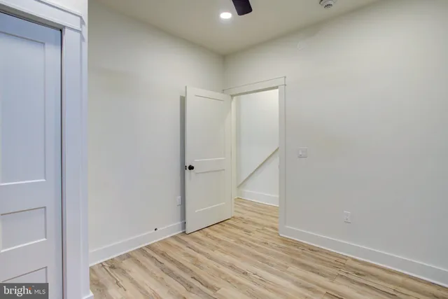 a view of room with wooden floor