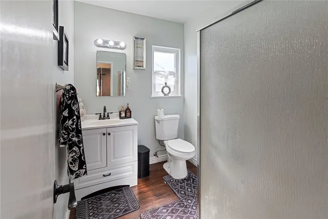 a bathroom with a toilet a sink and mirror