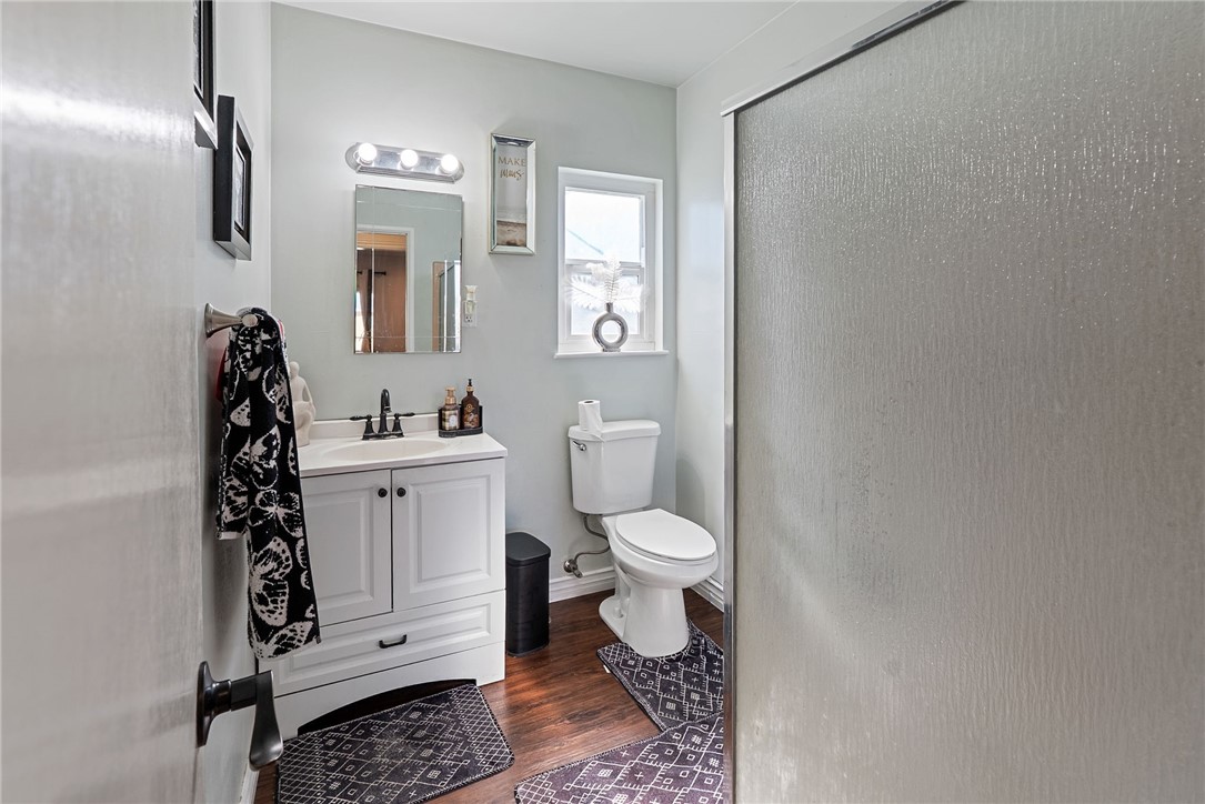 255 West Valencia Street Rialto, CA 92376 - Photo 13 of 34 a bathroom with a toilet a sink and mirror