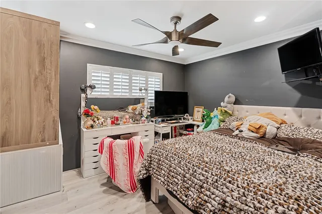 a bedroom with bed and tv