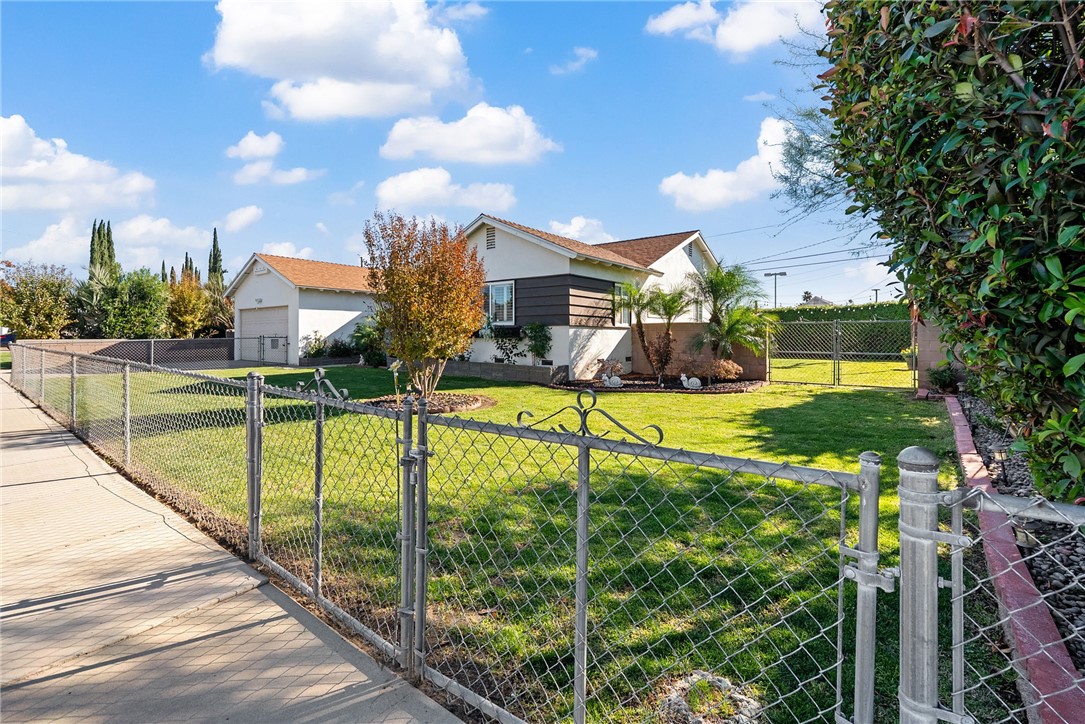 255 West Valencia Street Rialto, CA 92376 - Photo 2 of 34 a view of a house with swimming pool next to a yard