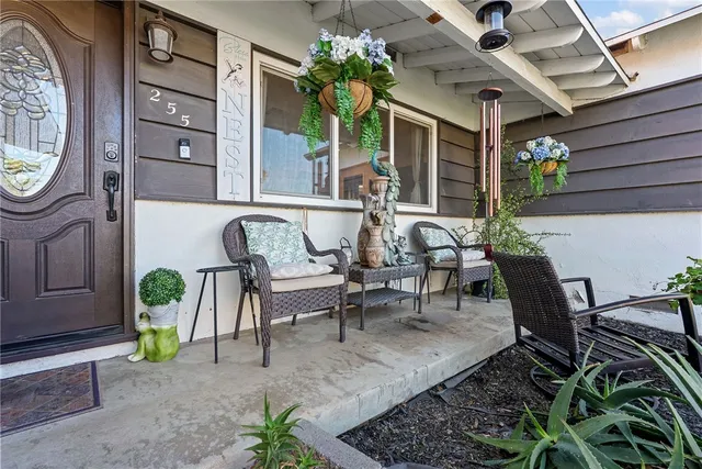 a view of a house with backyard and sitting area