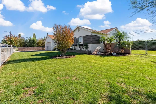 a view of a house with a yard and sitting area