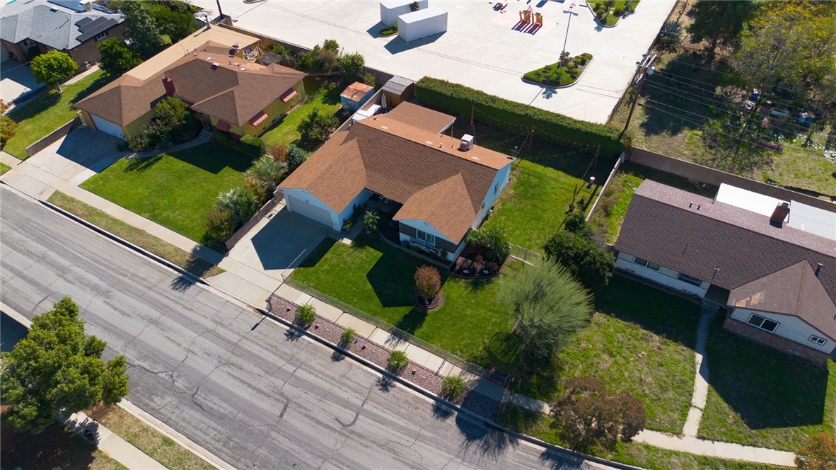 255 West Valencia Street Rialto, CA 92376 - Photo 4 of 34 an aerial view of a house with a yard and tennis court
