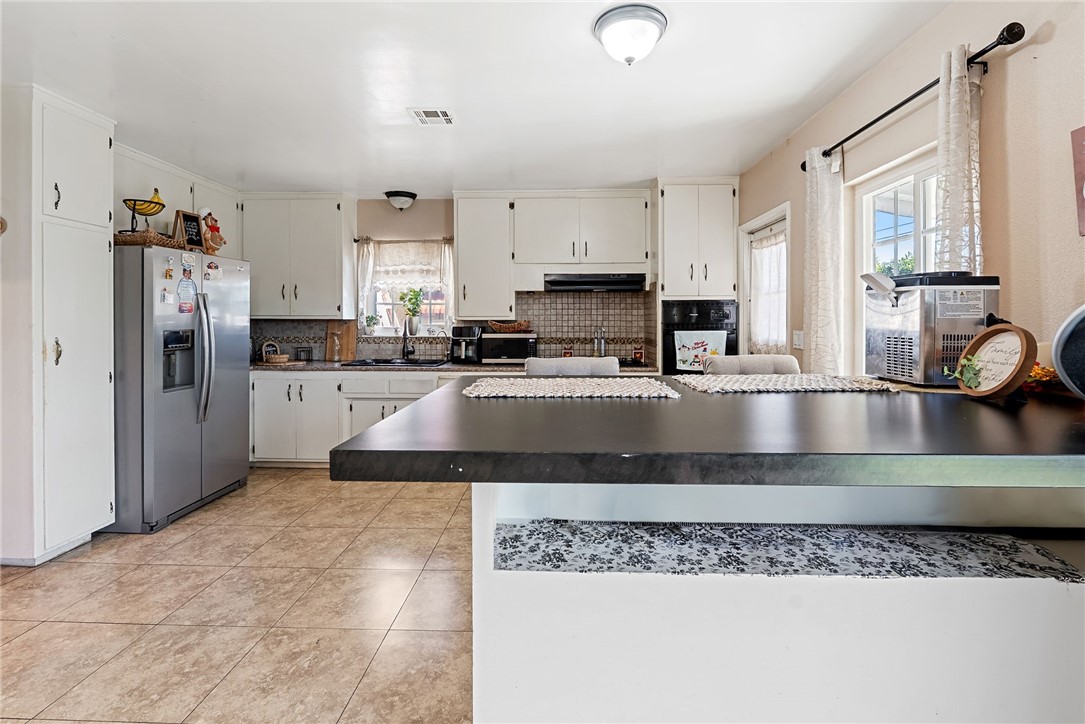 255 West Valencia Street Rialto, CA 92376 - Photo 10 of 34 a kitchen with stainless steel appliances granite countertop a sink stove and refrigerator