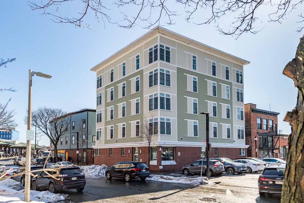 10 Roxbury Street Boston, MA 02119 - Photo 1 of 20 a front view of a building with lot of cars and trees