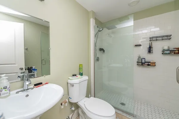 a white toilet sitting next to a bathroom sink