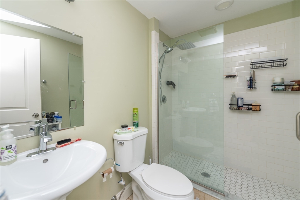 10 Roxbury Street Boston, MA 02119 - Photo 11 of 20 a white toilet sitting next to a bathroom sink