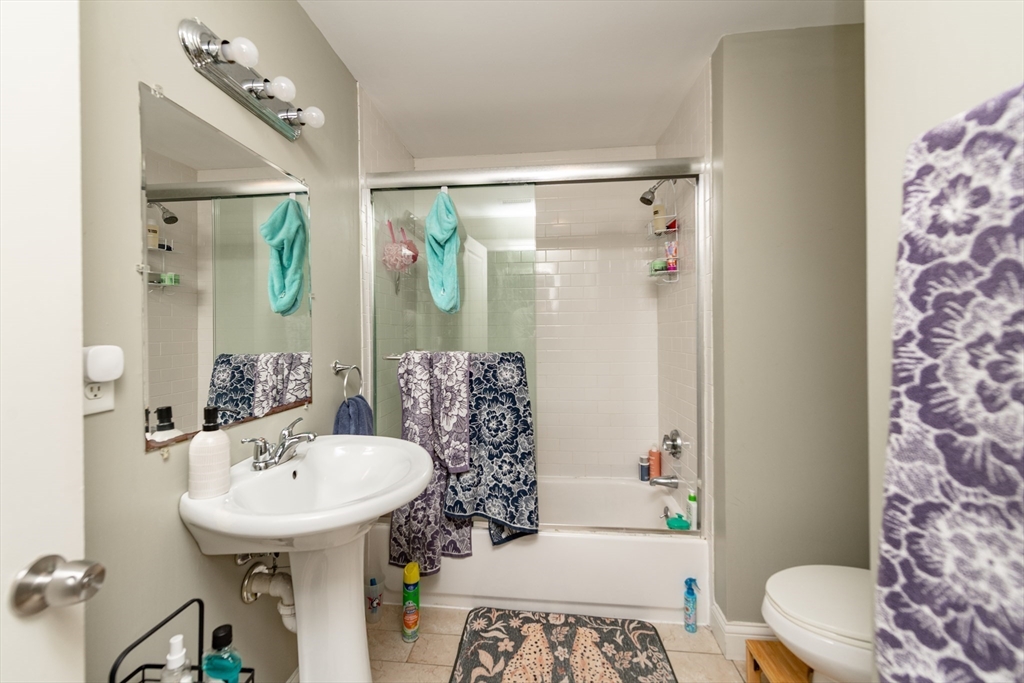 10 Roxbury Street Boston, MA 02119 - Photo 13 of 20 a bathroom with a sink toilet and shower