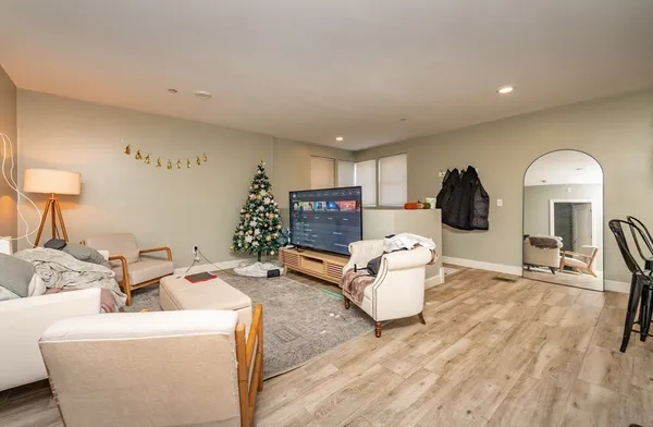 a living room with furniture and a wooden floor