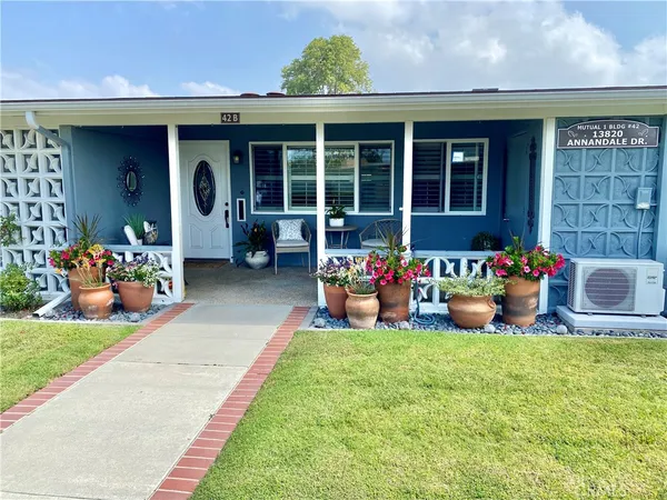 a front view of a house with outdoor seating