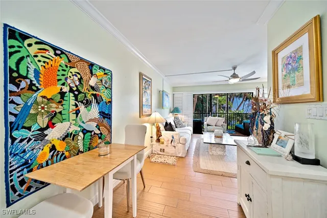 a living room with furniture and painting on the wall