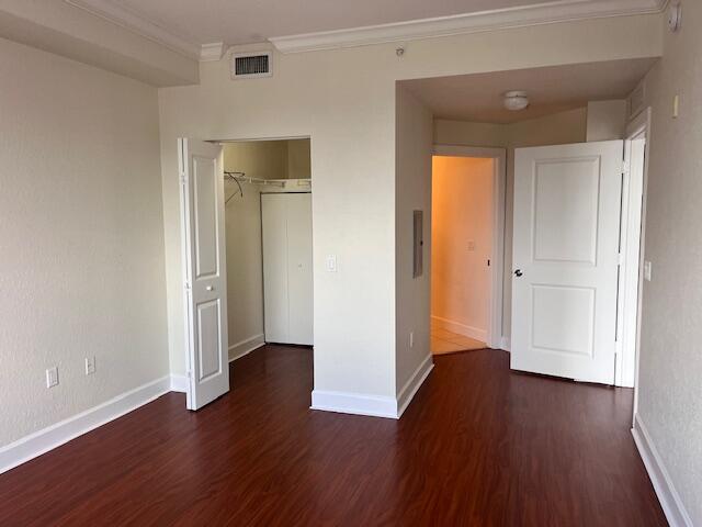 3 Renaissance Way, Unit 411 Boynton Beach, FL 33426 - Photo 3 of 9 an empty room with wooden floor and closet