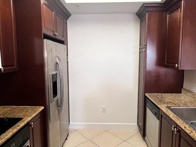 3 Renaissance Way, Unit 411 Boynton Beach, FL 33426 - Photo 4 of 9 a kitchen with stainless steel appliances granite countertop a refrigerator and a stove