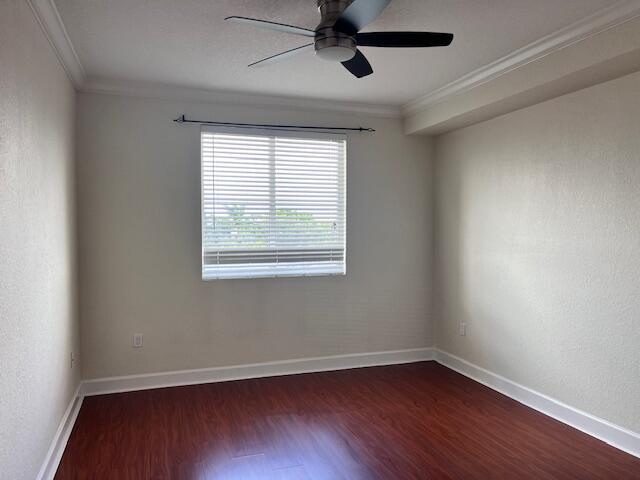3 Renaissance Way, Unit 411 Boynton Beach, FL 33426 - Photo 6 of 9 a view of an empty room with wooden floor and a window