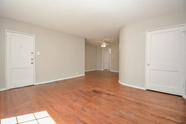 a view of an empty room and wooden floor