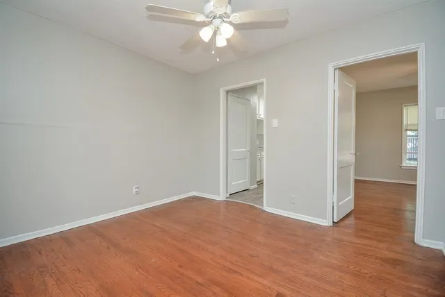 a view of an empty room with wooden floor