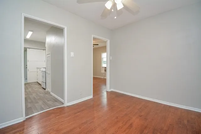 a view of a hallway with wooden floor