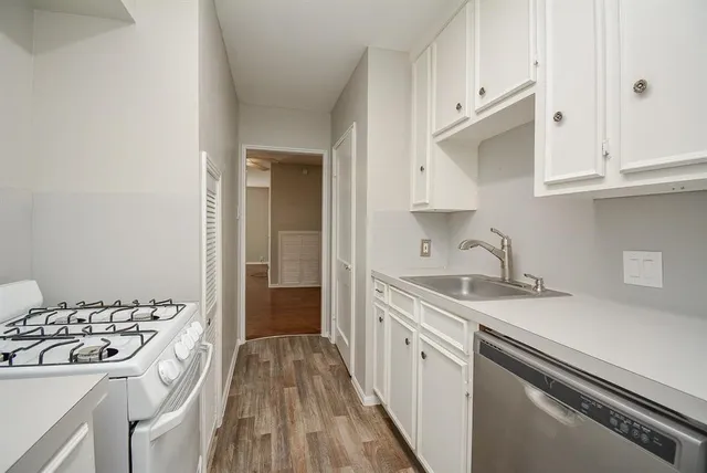 a kitchen with a sink stove and cabinets