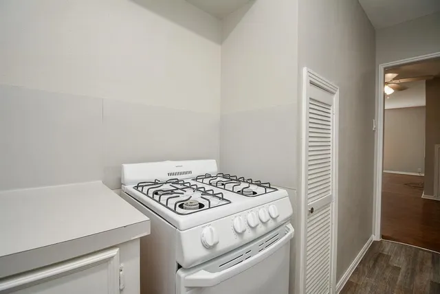 a white stove top oven sitting inside of a kitchen