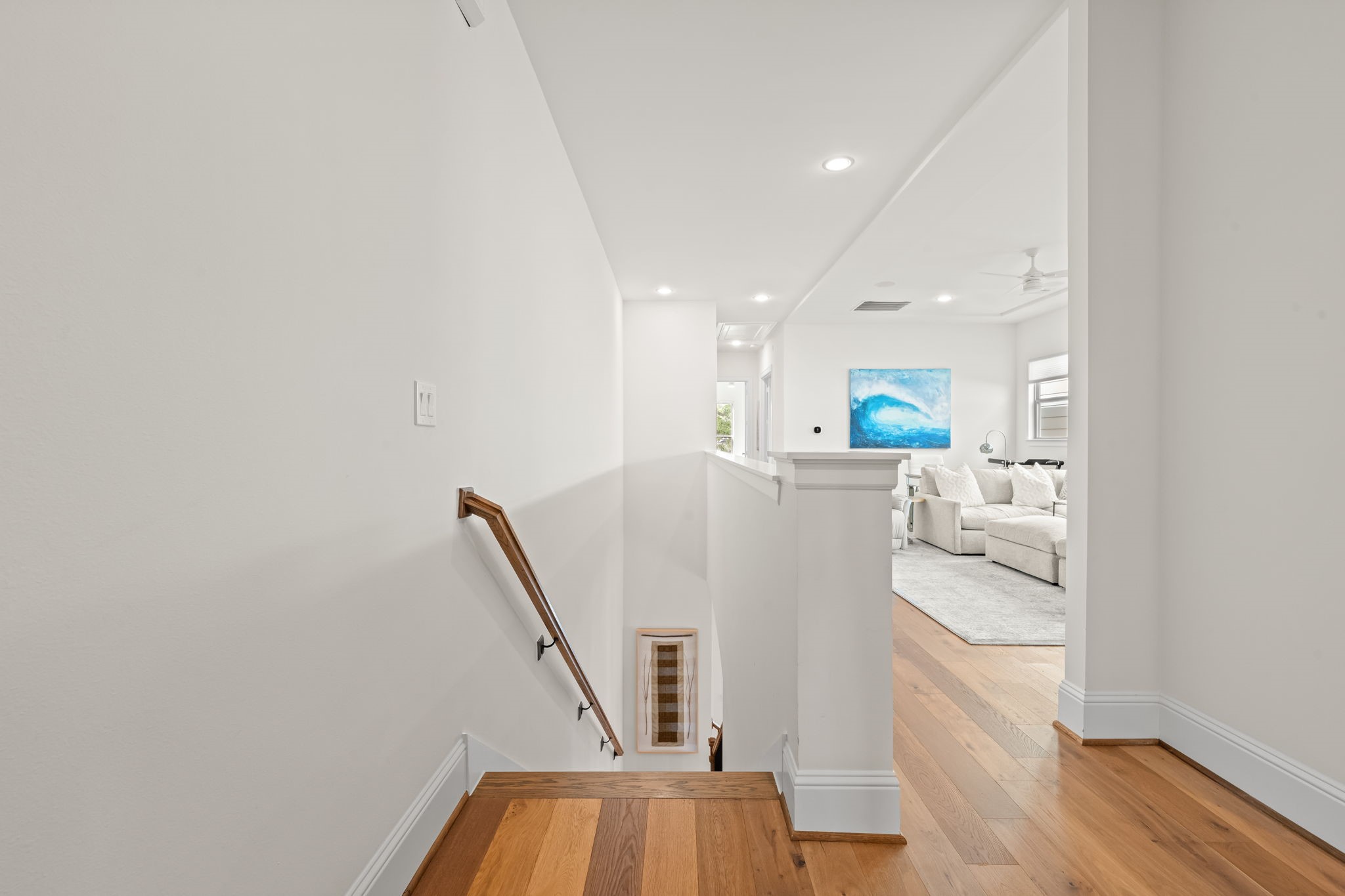110 East 26th Street, Unit B Houston, TX 77008 - Photo 19 of 43 The upstairs landing welcomes you with a sense of openness, providing significant separation between the luxurious primary suite and the secondary bedrooms. This spacious layout ensures maximum privacy, creating a graceful transition between the versatile bonus room and the home's private sleeping quarters.